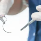 doctor-holding-surgical-forceps-suture-260nw-1224012658